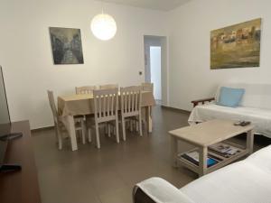 a living room with a table and a couch at Turina House in Las Palmas de Gran Canaria