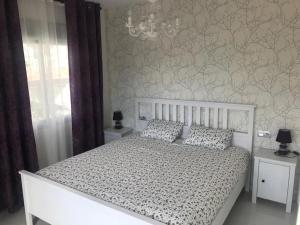 a bedroom with a white bed with a patterned wall at Villa Luxury - Private Pool - Wifi - Solarium in Alicante +62 photos