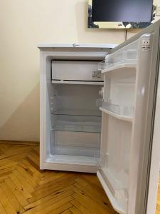 an empty refrigerator with its door open in a room at Mimoza Pansiyon in Antalya