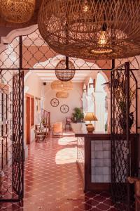 a living room with a table and a ceiling at Ojala in Antigua Guatemala