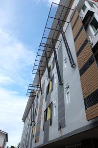 a building with a lot of glass panels on it at Puangpech Place in Lampang