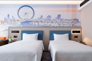 Letto o letti in una camera di Hampton by Hilton Guangzhou Jinshazhou