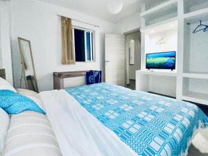 A bed or beds in a room at Marmaraki Village House & Apartments