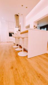 a kitchen with a white table and chairs on a wooden floor at Newly Renovated Super-Chic Apartment in Nicosia +12 photos