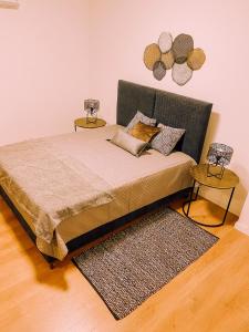 a bedroom with a bed with two side tables at Newly Renovated Super-Chic Apartment in Nicosia