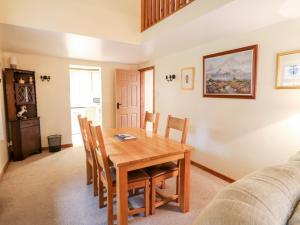 a dining room with a wooden table and chairs at Number 4 in Hartington