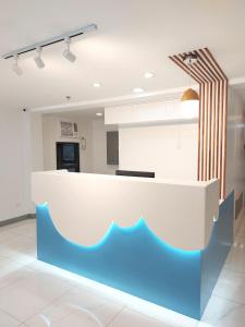 a kitchen with a blue and white counter top at airobedz MAKATI - A Value Hotel in Manila