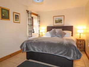 a bedroom with a large bed and two lamps at Number 5 in Buxton