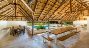 a large room with a table and chairs and a pool at Pine Valley in Lanseria