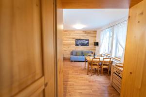 a kitchen and dining room with a table and chairs at Apartmány Pod Křížovým vrchem Adršpach in Adršpach