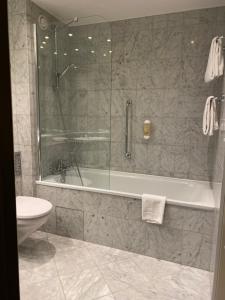 a bathroom with a shower and a tub and a toilet at Country Hotel Timmendorfer Strand in Timmendorfer Strand