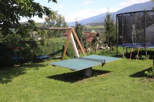 a swing set in a yard with a playground at Pechhof in Innsbruck