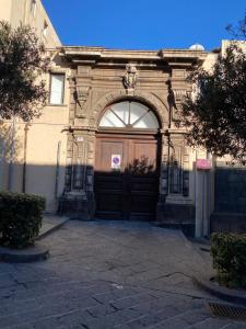 a large building with a large wooden door at Omar's Nest in Catania