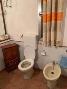 a bathroom with a toilet and a sink at BnB Convalis in Palermo