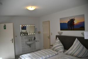a bedroom with a bed and a sink at Haus am Bach in Bad Wörishofen +117 photos