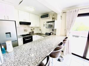 a kitchen with a granite counter top in a room at C&C HOTEL VIBES Randpark Ridge JHB 14 Units Available in Boskruin
