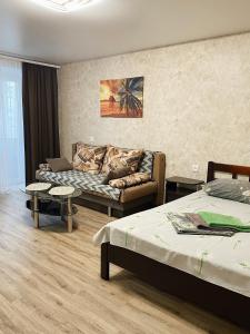 a living room with two beds and a couch at Apartment - Sobornyi Prospekt 97 in Zaporozhye