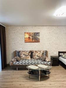 a living room with a couch and two tables at Apartment - Sobornyi Prospekt 97 in Zaporozhye