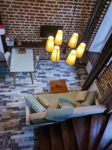 a living room with a couch and a brick wall at Freedom Square Studios in Tbilisi City