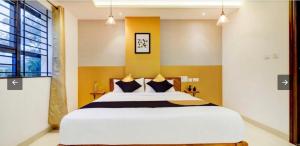 a bedroom with a large bed and a window at SERENE INTERNATIONAL in Bengaluru +11 photos