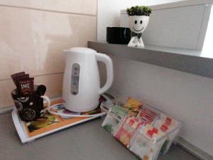 a kitchen counter with a coffee maker on a shelf at Studio Apartman ZENICA in Zenica