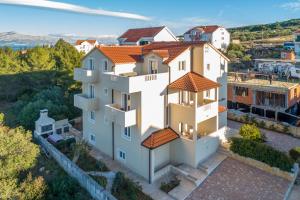 an aerial view of a white house with orange roofs at Villa Ankora in Supetar