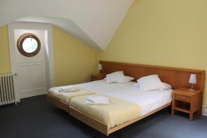 Postel nebo postele na pokoji v ubytování Le Cénacle