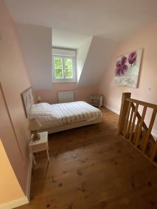 a bedroom with a bed in a attic at La Petite Maison - Maison de Campagne aux portes du Perche in Irai