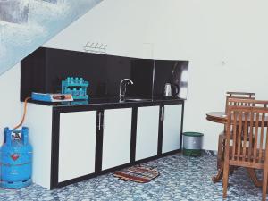 Kuchyň nebo kuchyňský kout v ubytování Pearl Holiday Inn