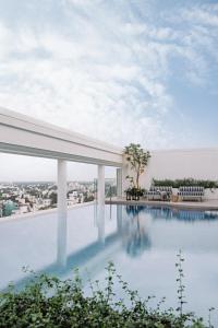 a swimming pool on the roof of a building at The Raintree, St. Mary’s Road in Chennai