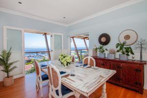 a dining room with a table and chairs at A Boat House in Simonʼs Town