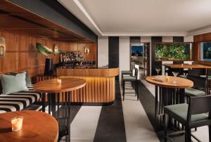 a restaurant with tables and chairs and a bar at The Raintree, St. Mary’s Road in Chennai