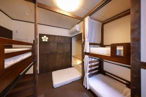a group of bunk beds in a room at Sendai Guest House UMEBACHI in Sendai