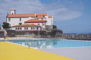 a large swimming pool in front of a building at Scenic Comfort D in Ponta Delgada
