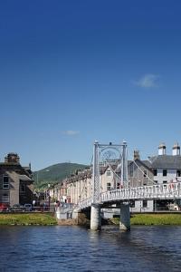 a bridge over a body of water with buildings at King Street Apartment in Inverness