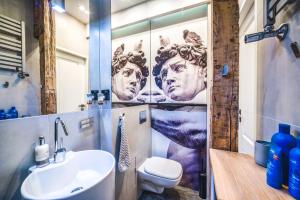 a bathroom with a shower with a toilet and a sink at Apartament Przy Żurawiu in Gdańsk