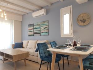 a living room with a table and a couch at Tamaris Homes in Mastihari
