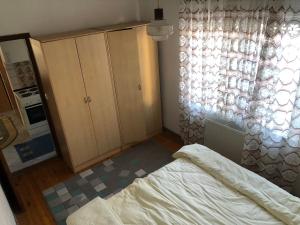 a bedroom with a bed and a large window at Apartment in Sarajevo