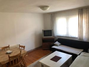 a living room with a couch and a table at Apartment in Sarajevo