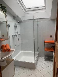 a bathroom with a shower and a tub and a sink at Landhaus Kurz in Golling an der Salzach
