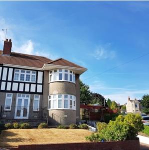 a large brick house with white windows on it at Gateway to Gower in Dunvant