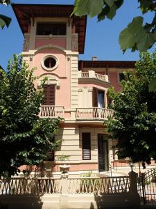 a building with a clock tower with a balcony at Petit Chateau in Montecatini Terme