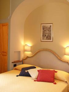 a bedroom with a bed with two pillows on it at Petit Chateau in Montecatini Terme