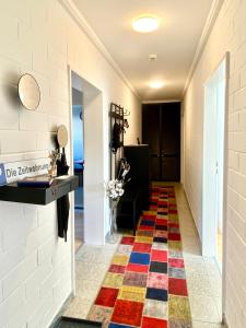 a hallway with a colorful rug on the floor at Die Zeitwohnung in Hochheim am Main