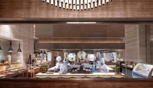 two chefs preparing food in a large kitchen at Fairmont Riyadh in Riyadh