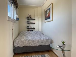 a bedroom with a bed and a glass table at ParkSide Loft in Kalamata