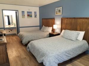 a hotel room with two beds and a window at Blue Sky Inn- Complimentary Happy Hour Th-Sun, Veteran owned, Full Breakfast, Best green space, 1 mile from Blue Ridge, Fire Pit in Blue Ridge