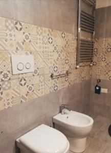 a bathroom with a toilet and a sink at La Taverna Appartamento Scala a Chiocciola in Follonica