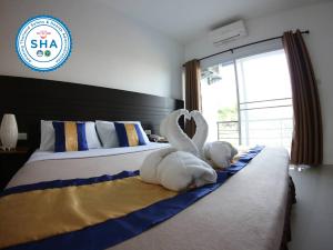 a stuffed animal is laying on a bed at P Bliss hotel in Phayao