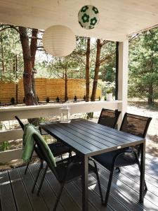 a table and chairs on a screened in porch at Domki Między Drzewami in Bartoszylas